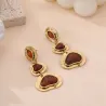Boucles d’oreilles pendantes dorées – pierres effet ambre