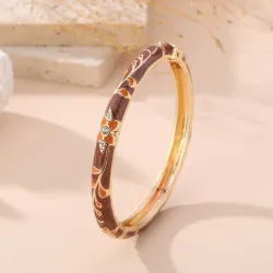 Bracelet jonc doré émaillé à motifs fleuris et strass
